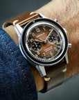 Alfa Zulu aviation watch on a brown leather strap, side profile, brown dial with applied indices, worn by a male pilot, by DEDALE