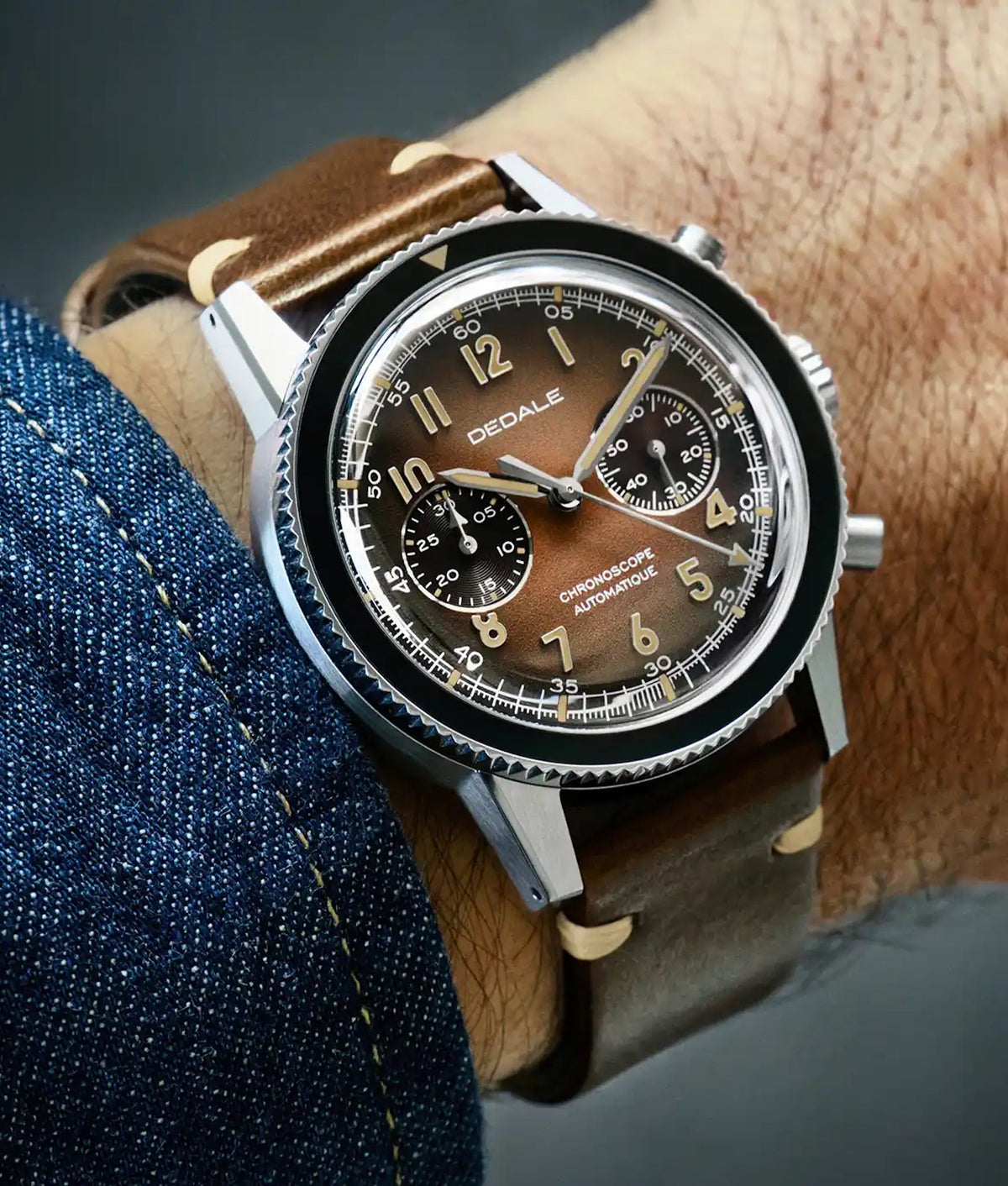 Alfa Zulu aviation watch on a brown leather strap, side profile, brown dial with applied indices, worn by a male pilot, by DEDALE