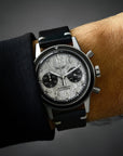 Chronograph watch with a meteorite dial, Widmanstätten patterns, worn on a men pilot's wrist
